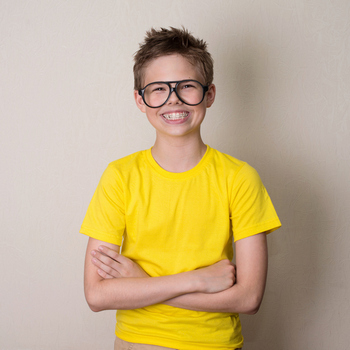 Happy teen boy in braces and eyeglasses smiling
